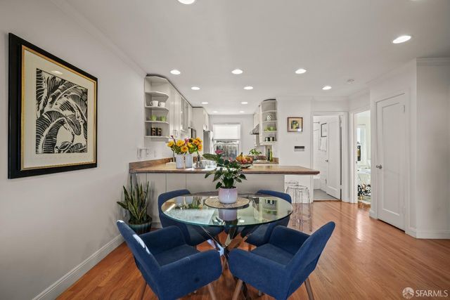 a large kitchen with stainless steel appliances granite countertop a stove and a sink