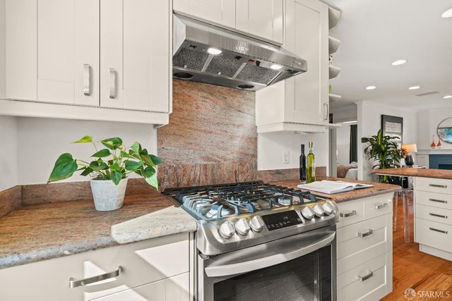 a bedroom with a bed a dresser and chair