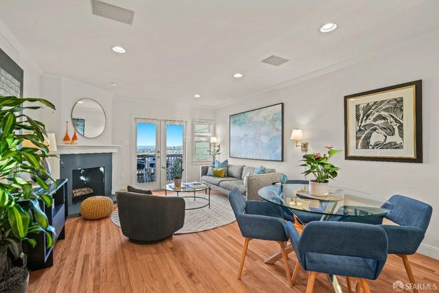 a living room with patio furniture and a potted plant