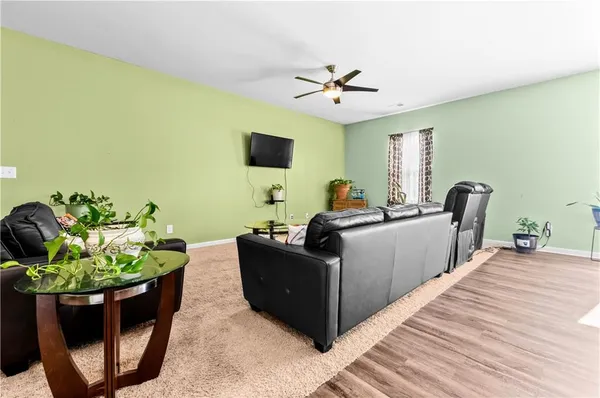 a living room with furniture and a potted plant