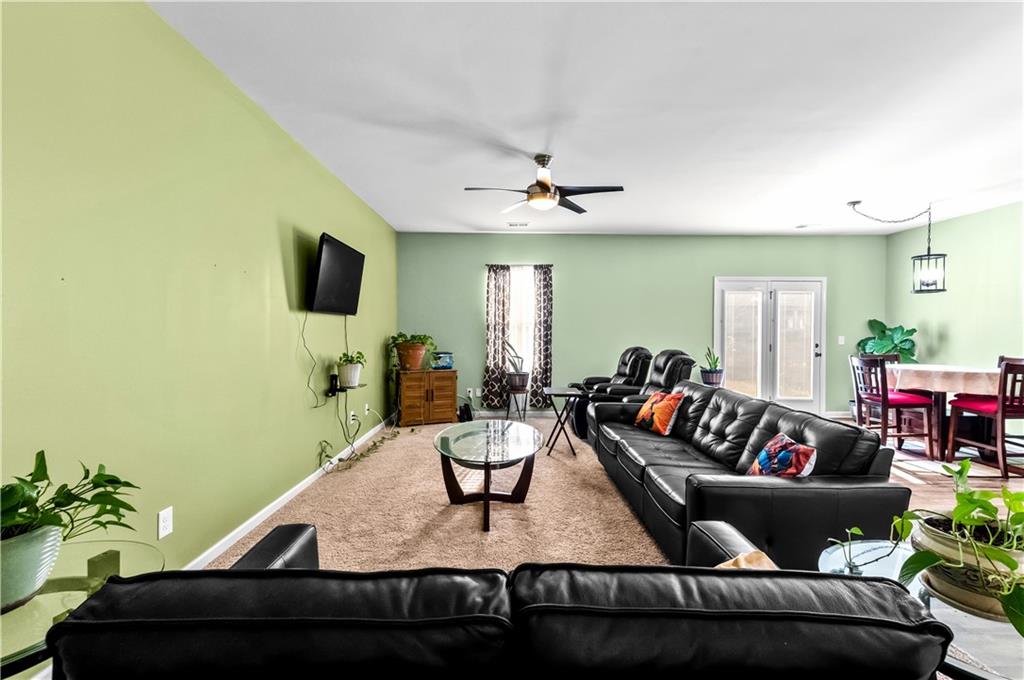 95 Randette Drive Covington, GA 30016 - Photo 14 of 28 a living room with furniture and a flat screen tv