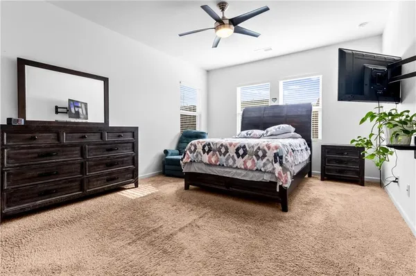 a bedroom with a bed and a tv on the dresser