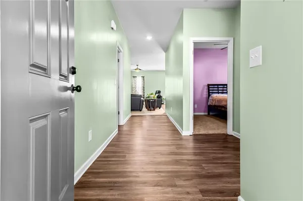 a view of a hallway with wooden floor