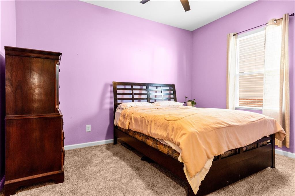 95 Randette Drive Covington, GA 30016 - Photo 5 of 28 a bed room with a bed and a refrigerator