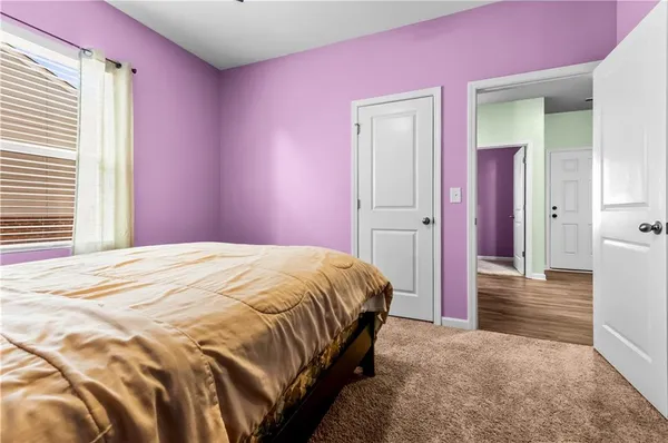 a bedroom with a bed and a mirror