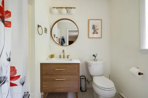 a bathroom with a toilet a sink and a mirror