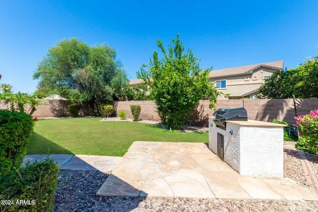 a view of a backyard with sitting area