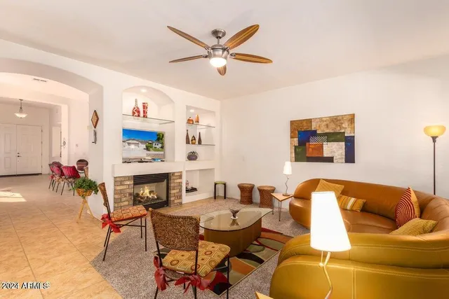 a living room with furniture kitchen view and a fireplace