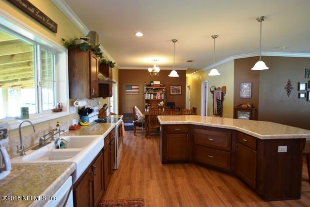 110 Jones Road Crescent City, FL 32112 - Photo 12 of 55 a large kitchen with lots of counter space a sink and living room view