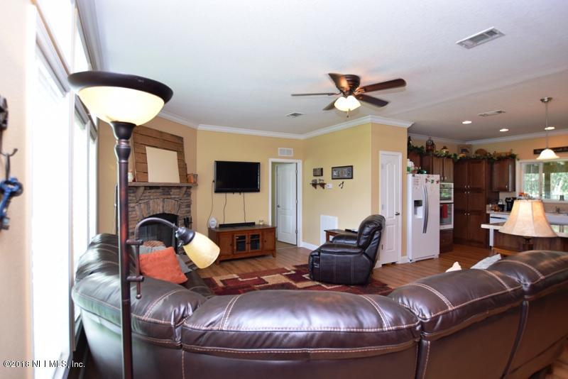 110 Jones Road Crescent City, FL 32112 - Photo 26 of 55 a living room with furniture and a chandelier