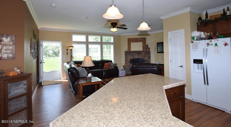 110 Jones Road Crescent City, FL 32112 - Photo 27 of 55 a living room with furniture fireplace and flat screen tv