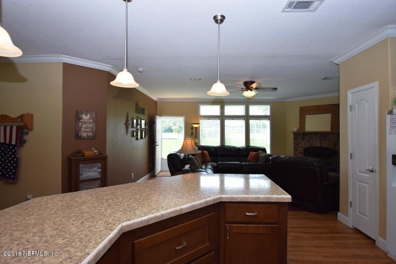 110 Jones Road Crescent City, FL 32112 - Photo 28 of 55 a kitchen with a sink and chandelier