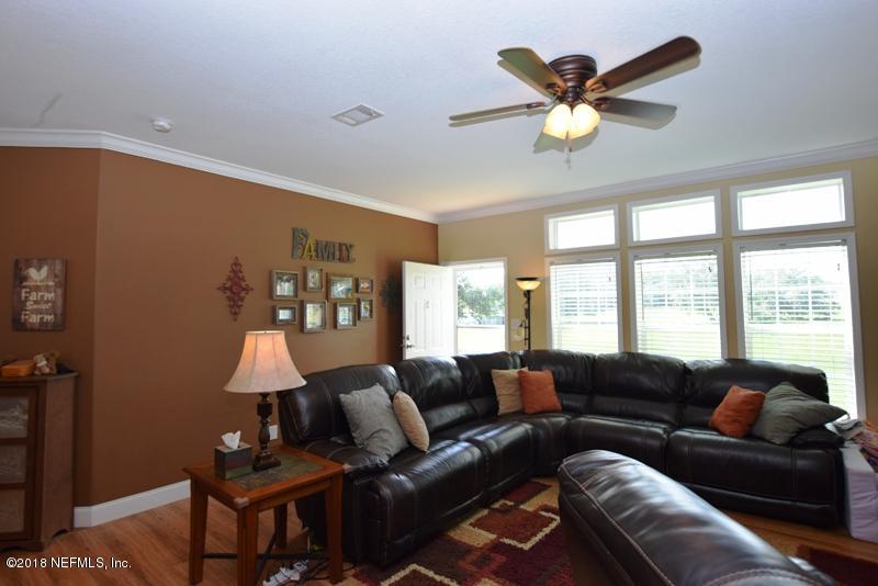 110 Jones Road Crescent City, FL 32112 - Photo 29 of 55 a living room with furniture a ceiling fan and a large window