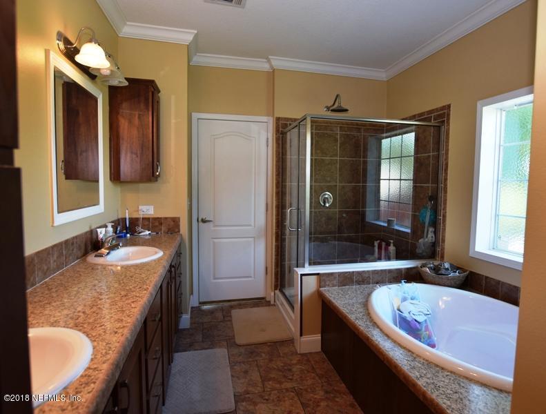 110 Jones Road Crescent City, FL 32112 - Photo 33 of 55 a bathroom with a granite countertop tub sink and mirror