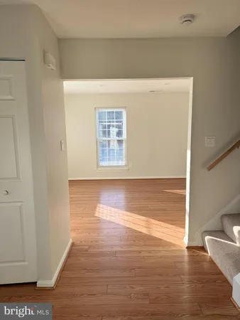 a view of room with window and wooden floor