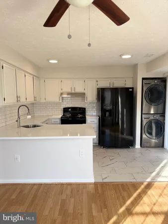 a kitchen with stainless steel appliances granite countertop a sink a stove and a refrigerator