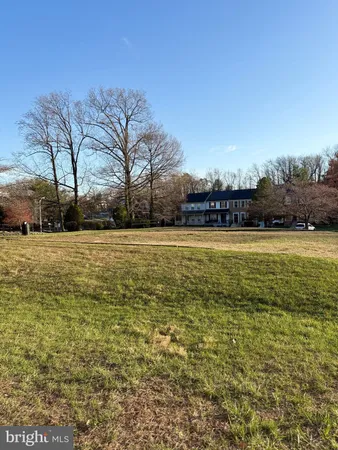 a view of a swimming pool and trees in the background