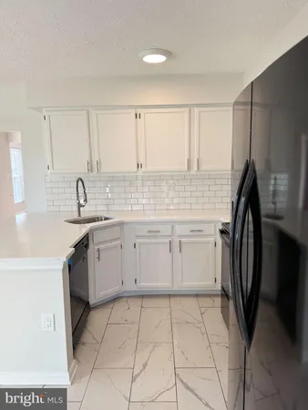 a kitchen with a sink a stove and refrigerator