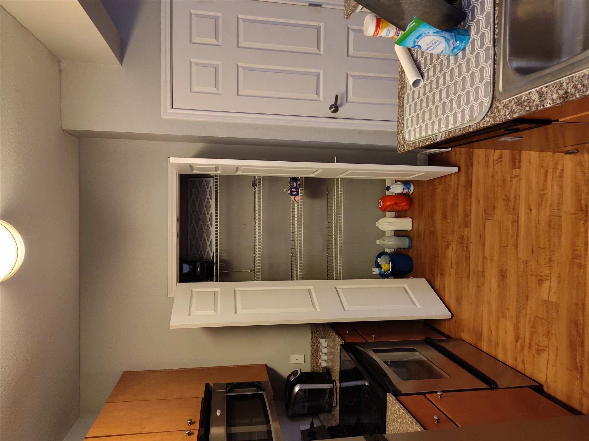 2502 Leon Street, Unit 304 Austin, TX 78705 - Photo 5 of 10 a kitchen with granite countertop a refrigerator and a stove