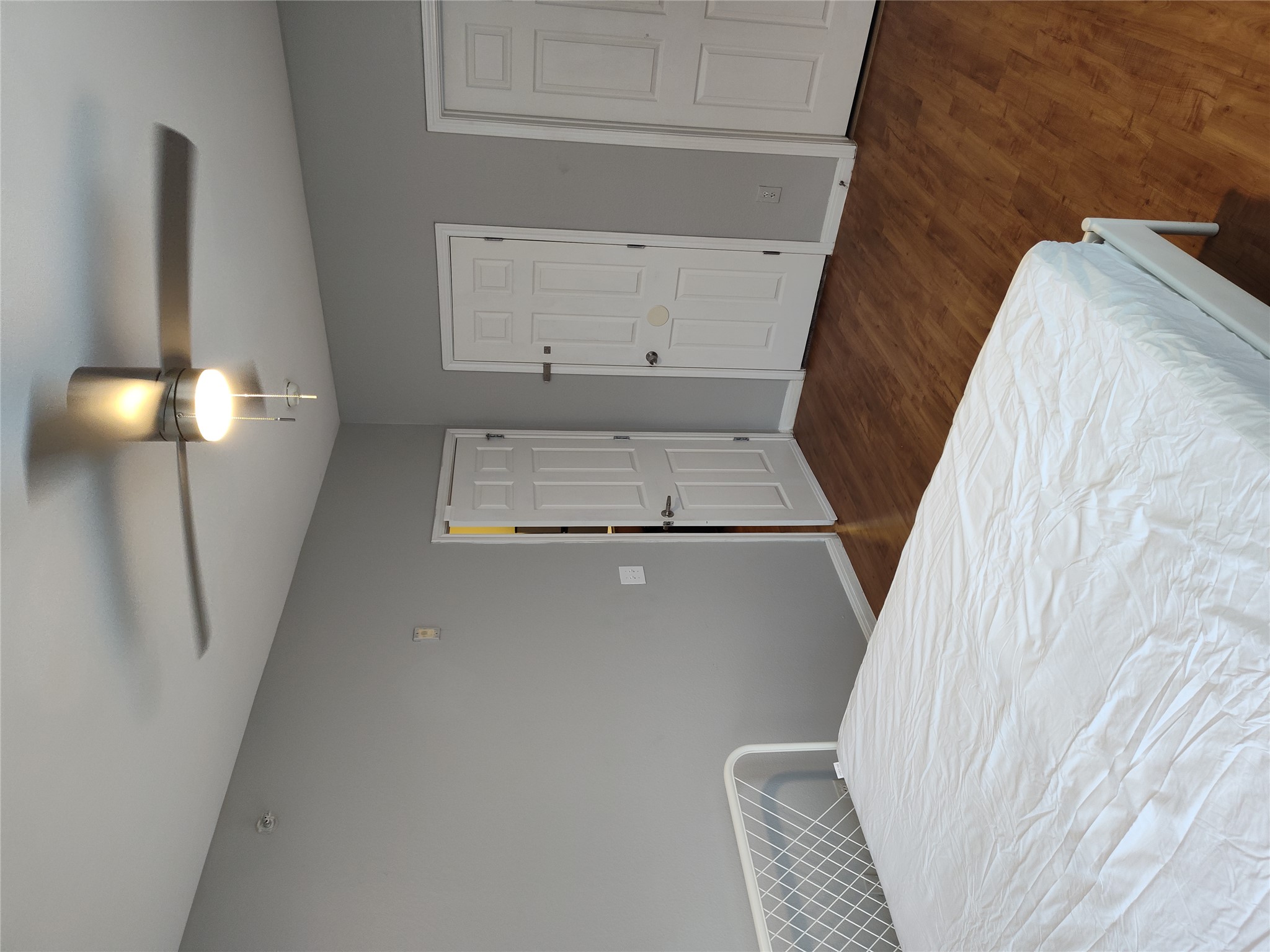 2502 Leon Street, Unit 304 Austin, TX 78705 - Photo 7 of 10 a bedroom with a bed and a chandelier