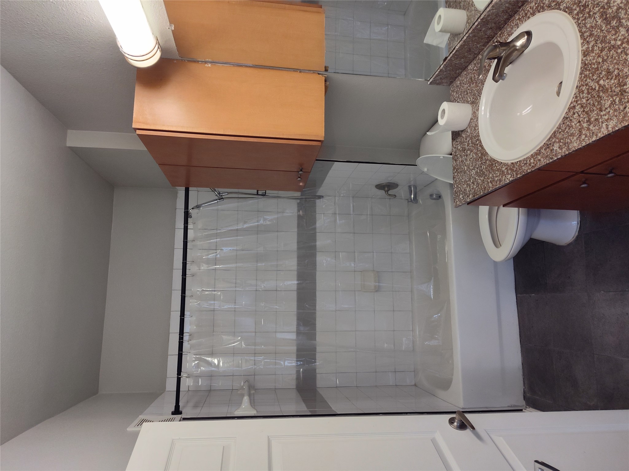 2502 Leon Street, Unit 304 Austin, TX 78705 - Photo 9 of 10 a bathroom with a granite countertop sink toilet and shower