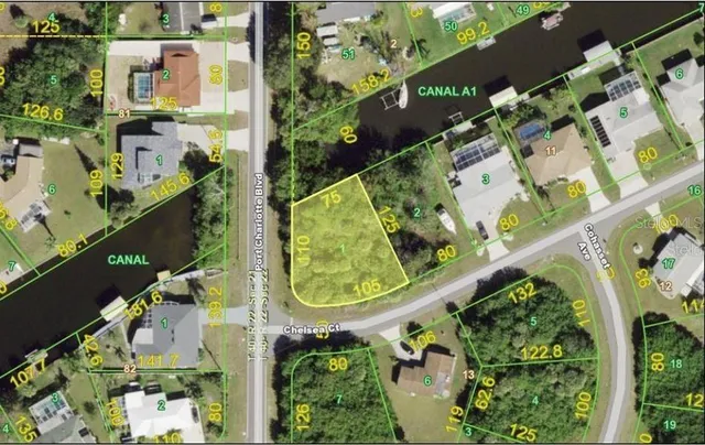 an aerial view of a multi story residential apartment building with a yard and garden