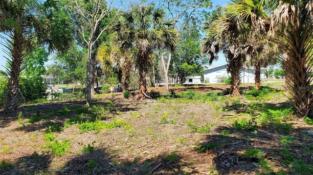 a backyard of a house with a yard and outdoor seating