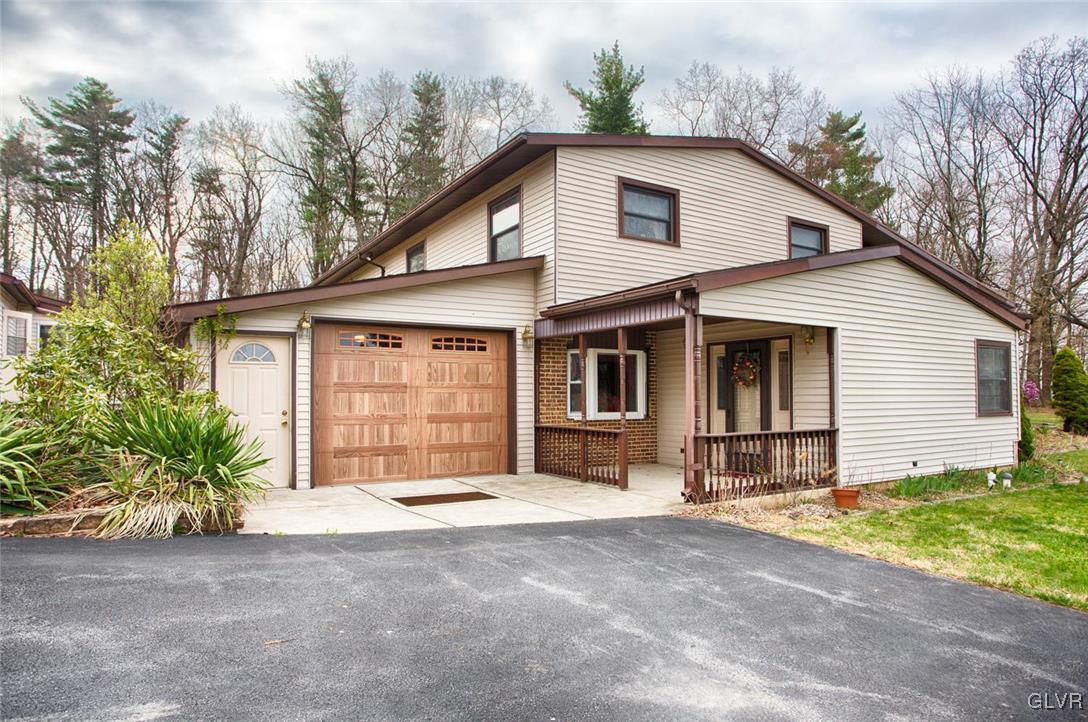 349 Meyer Road Nazareth, PA 18064 - Photo 1 of 38 a front view of a house with a yard and garage