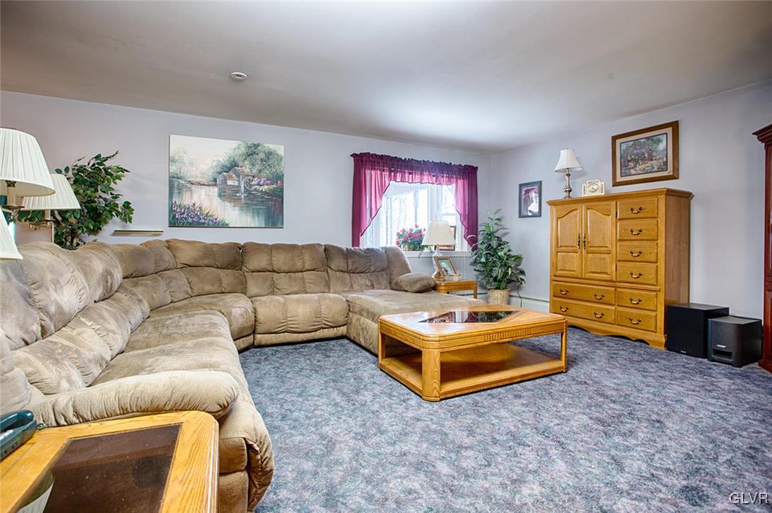 349 Meyer Road Nazareth, PA 18064 - Photo 10 of 38 a living room with furniture gym equipment and a flat screen tv