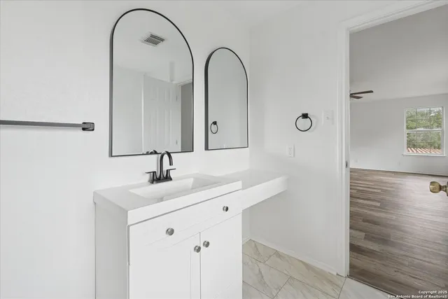 a bathroom with a double vanity sink and mirror