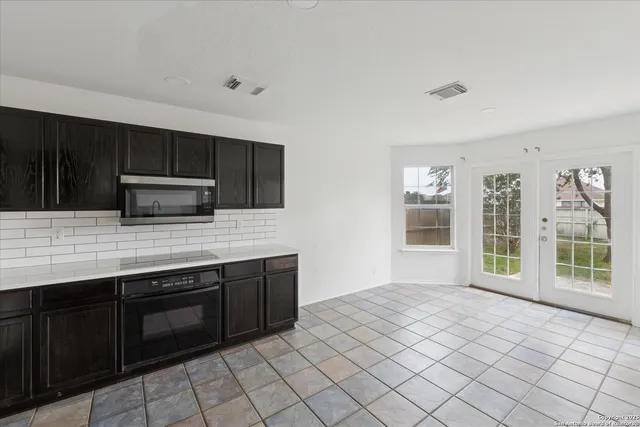 a kitchen with stainless steel appliances a stove sink and microwave