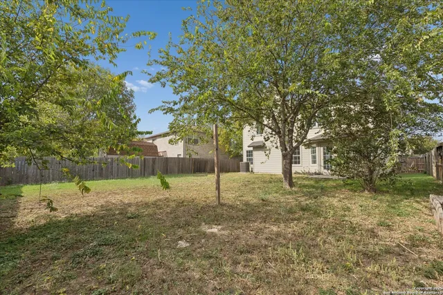 a backyard of apartments with large trees