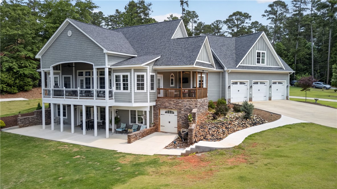 206 James Hare Road Anderson, SC 29626 - Photo 2 of 37 A spacious home with multiple garage doors and an inviting multi-level outdoor living space.