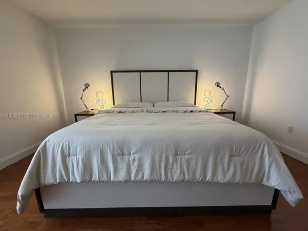 a bedroom with a bed and a table in it