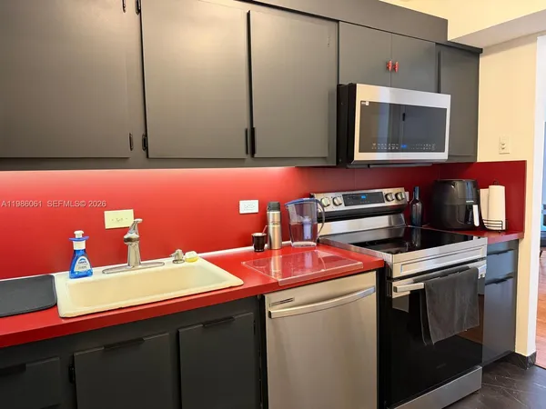 a kitchen with a sink cabinets and microwave