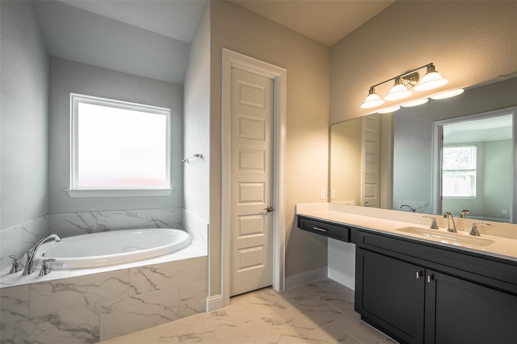 113 Old Trinity Way Georgetown, TX 78628 - Photo 13 of 27 Bathroom featuring vanity, a garden tub, light marble finish flooring, and plenty of natural light