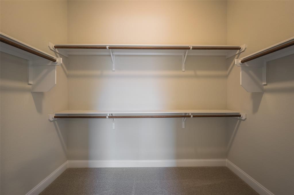 113 Old Trinity Way Georgetown, TX 78628 - Photo 14 of 27 Walk in closet featuring dark carpet
