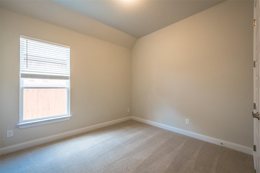 113 Old Trinity Way Georgetown, TX 78628 - Photo 18 of 27 Empty room featuring light carpet and lofted ceiling