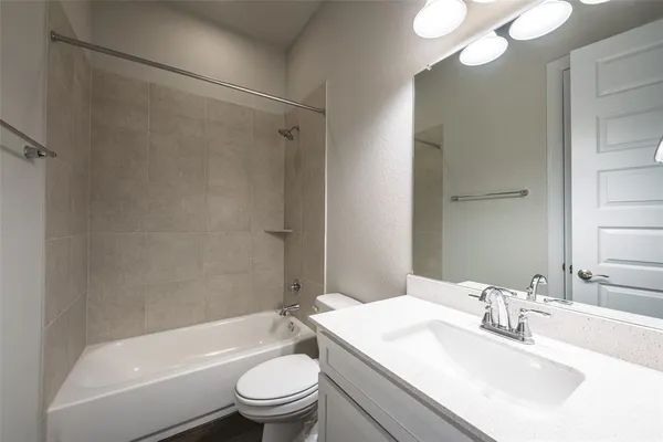 a bathroom with a sink a toilet and a bathtub