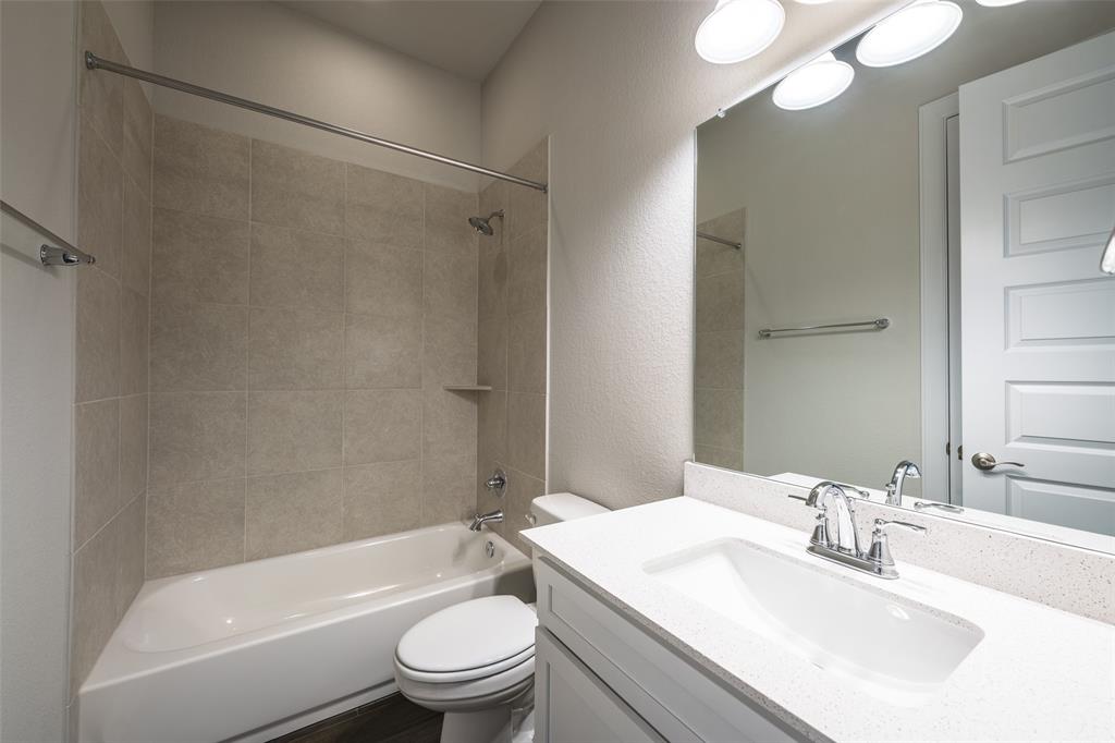 113 Old Trinity Way Georgetown, TX 78628 - Photo 20 of 27 Bathroom featuring vanity, shower / tub combination, and a textured wall