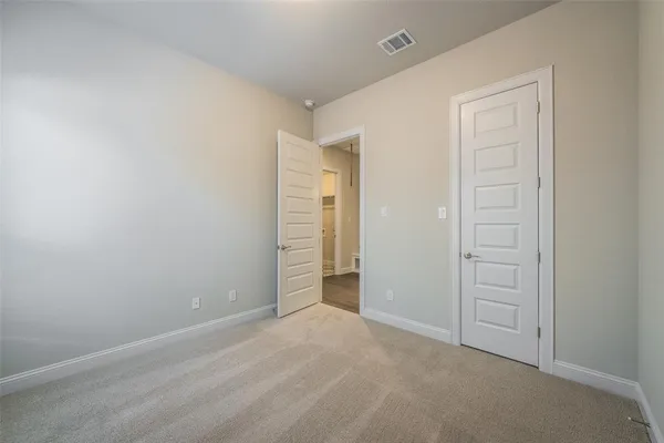 an empty room with closet area