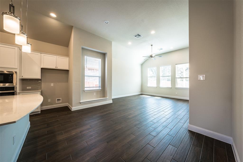 113 Old Trinity Way Georgetown, TX 78628 - Photo 7 of 27 Kitchen featuring decorative light fixtures, stainless steel appliances, white cabinetry, and healthy amount of natural light