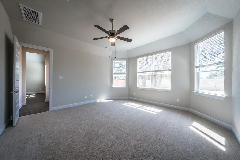 113 Old Trinity Way Georgetown, TX 78628 - Photo 10 of 27 Empty room with a ceiling fan and dark colored carpet