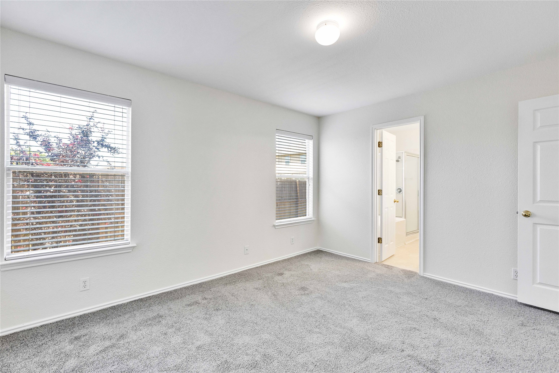 14418 Pebble Run Path Manor, TX 78653 - Photo 12 of 27 A spacious bedroom offers comfort and a private attached bath.