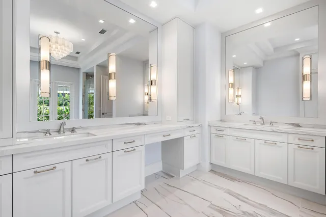 a large white bathroom with a sink and a mirror