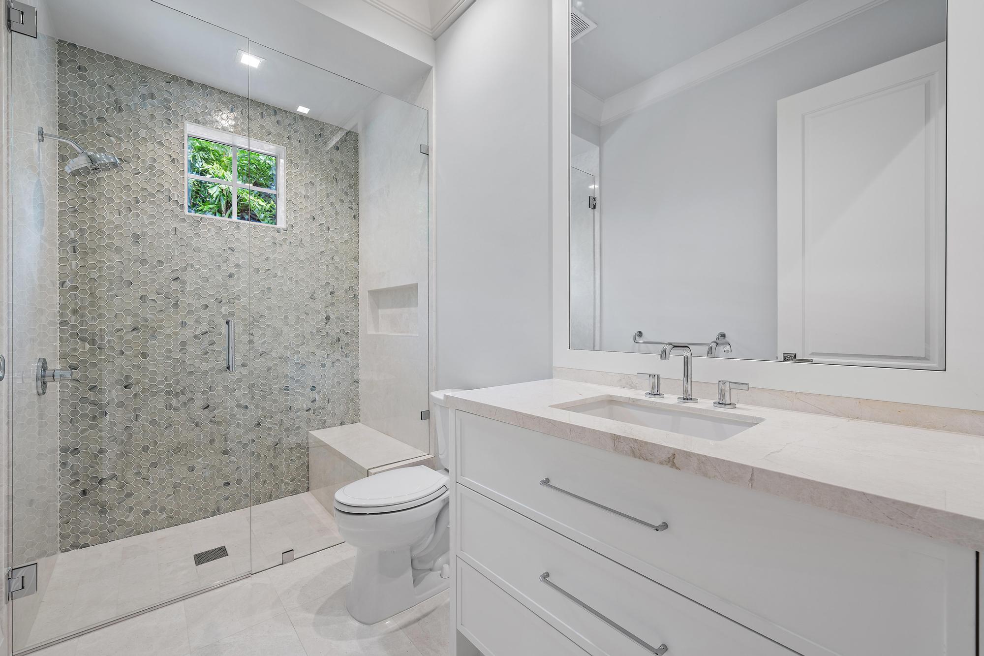 2917 Bluewater Cove Gulf Stream, FL 33483 - Photo 27 of 37 a bathroom with a sink a toilet and shower