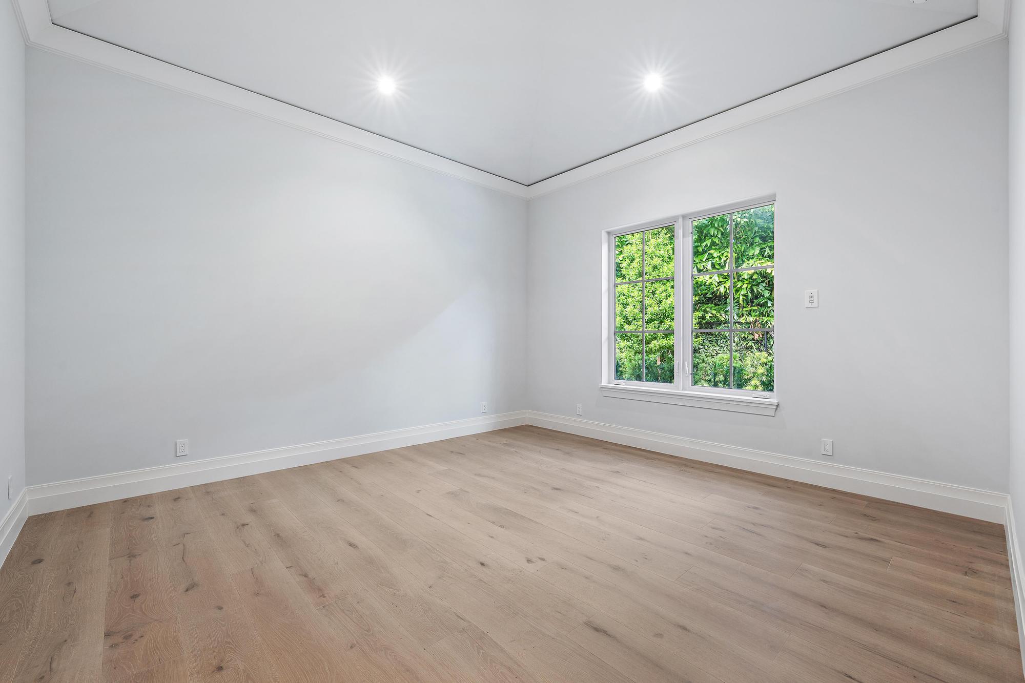 2917 Bluewater Cove Gulf Stream, FL 33483 - Photo 28 of 37 an empty room with wooden floor and windows