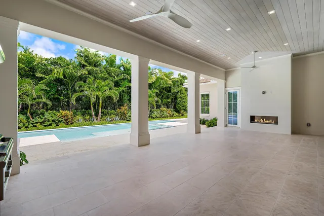 a view of an empty room with a fireplace and a large window