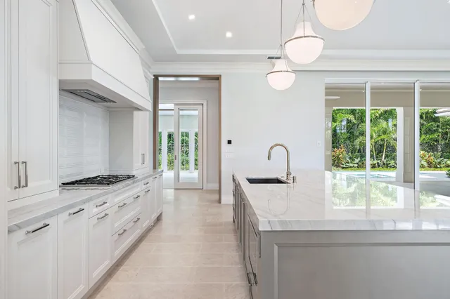 a kitchen with granite countertop a stove and a sink