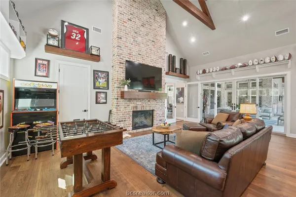 a living room with furniture a flat screen tv and a fireplace